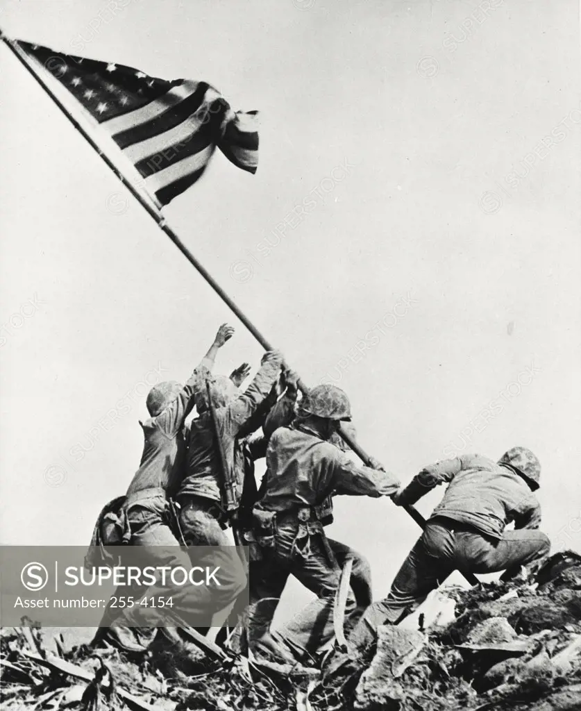 Army soldiers raising flag on mount Suribachi, Iwo Jima