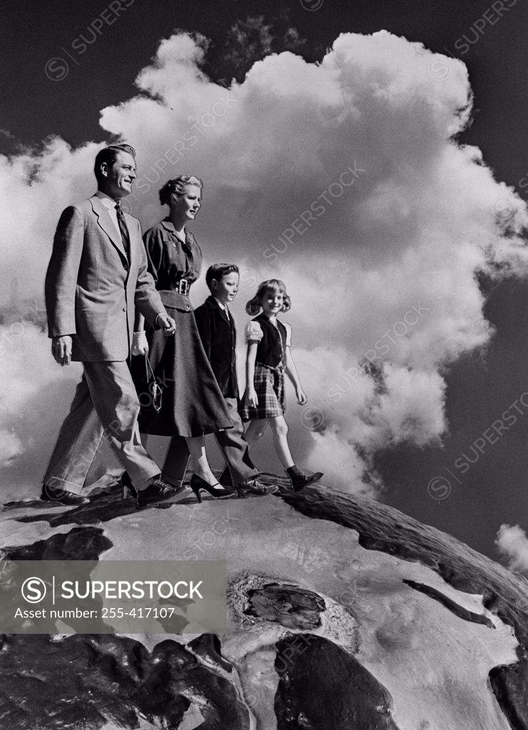 Stock Photo: 255-417107 Family with two kids walking in clouds