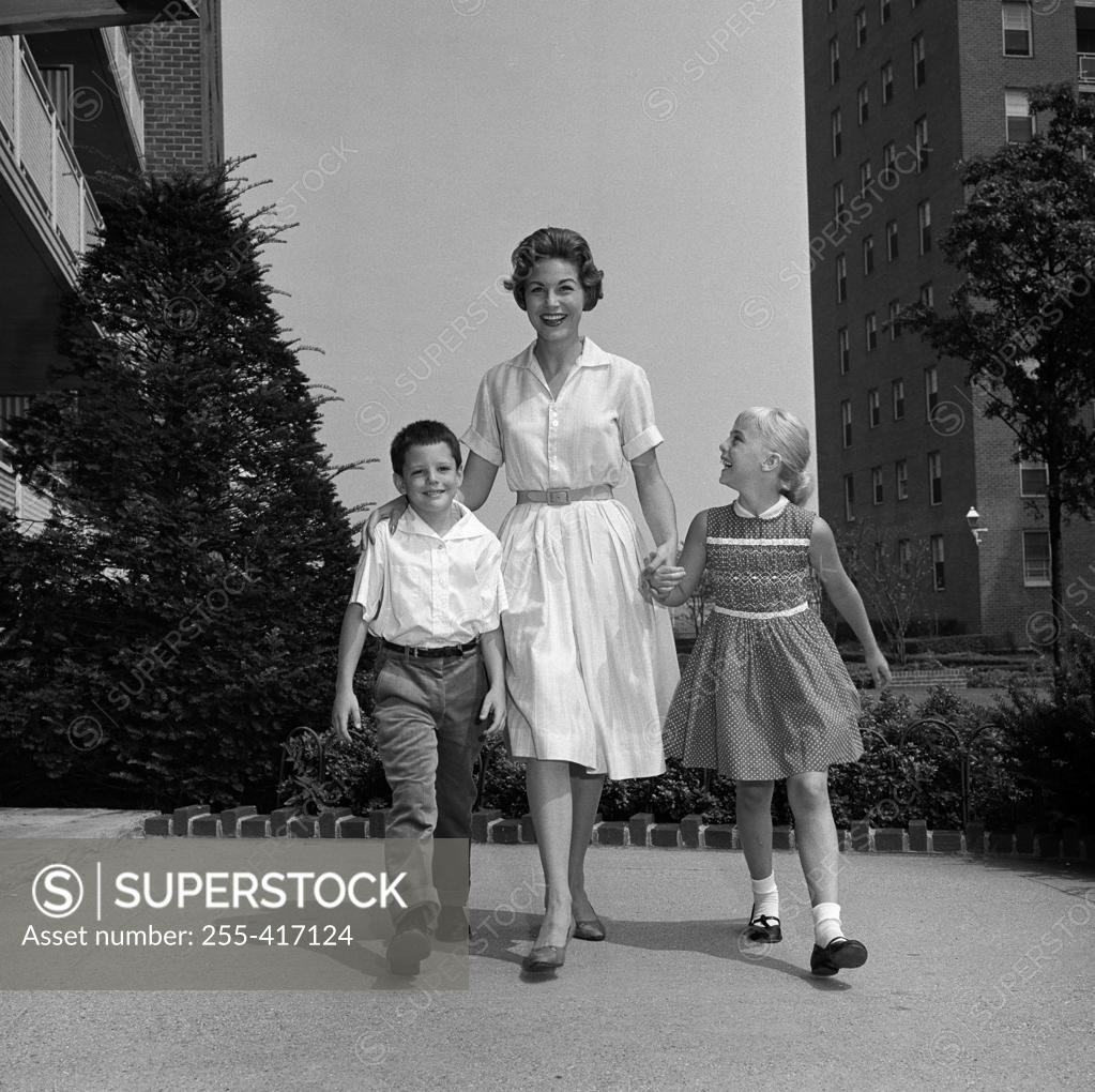 Stock Photo: 255-417124 Mother walking with son and  daughter side by side