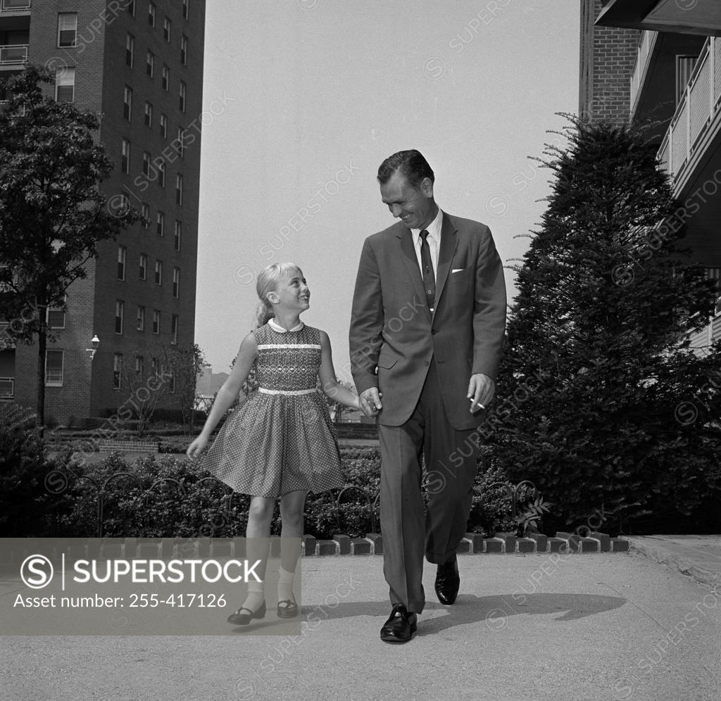 Stock Photo: 255-417126 Father walking hand in hand with daughter