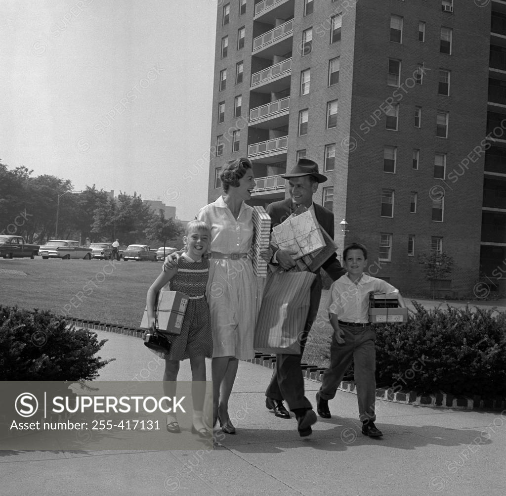 Stock Photo: 255-417131 Family with girl and boy coming back from shopping