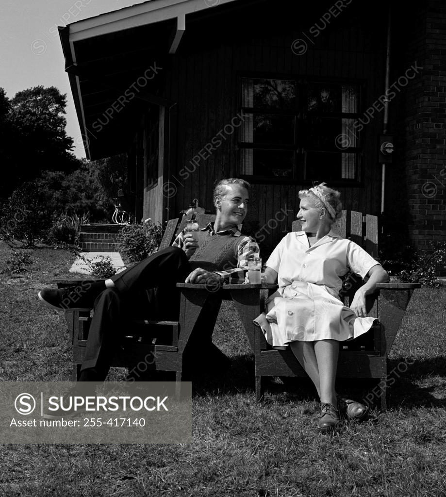 Stock Photo: 255-417140 Mature couple relaxing in garden chairs