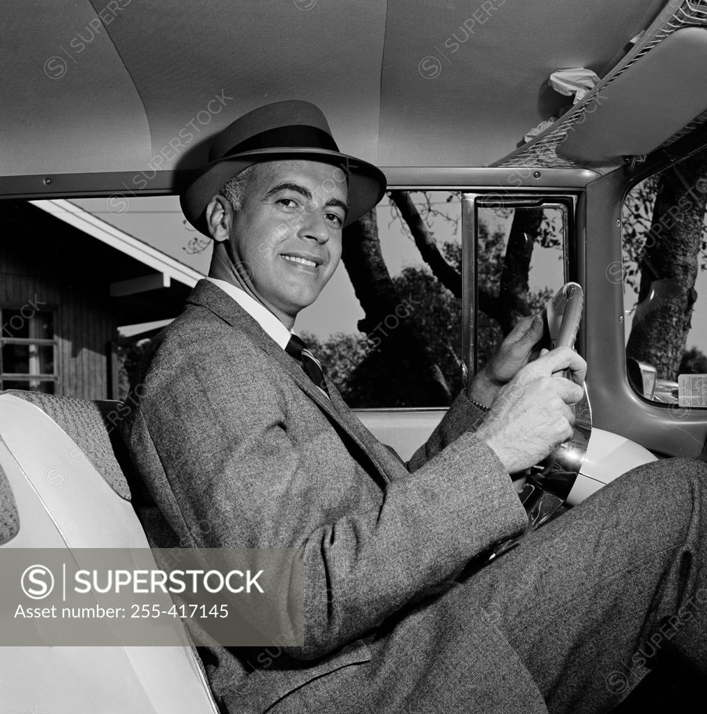 Stock Photo: 255-417145 Confident mid-adult man sitting inside of car