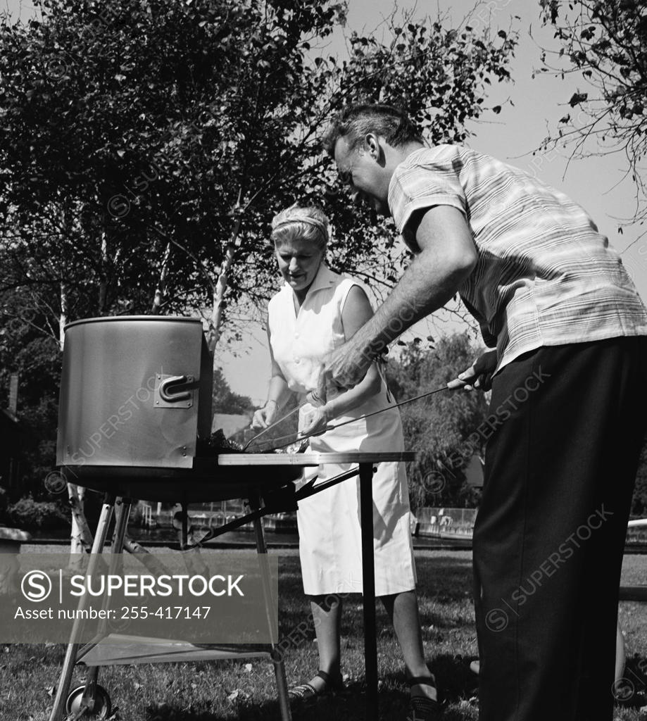 Stock Photo: 255-417147 Mature couple preparing barbecue