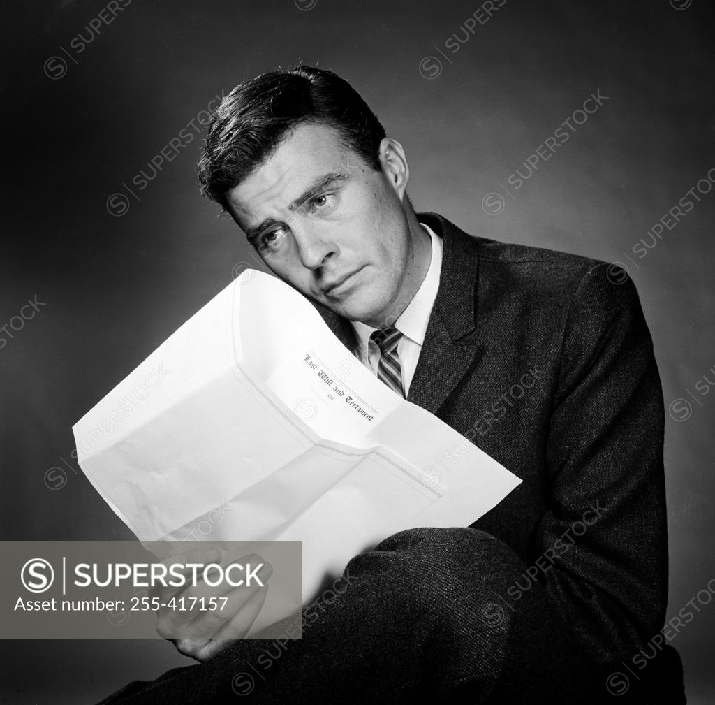 Stock Photo: 255-417157 Businessman reading document