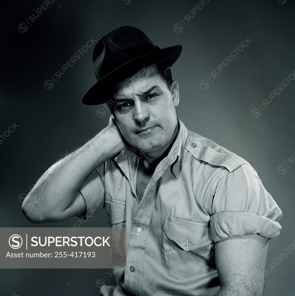 Stock Photo: 255-417193 Studio portrait of man wearing hat