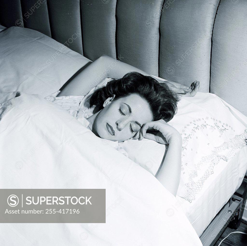 Stock Photo: 255-417196 Woman sleeping in bed