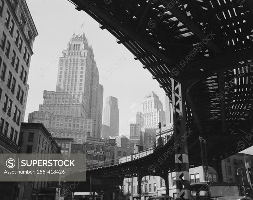Stock Photo: 255-418426 USA, New York State, New York City, Manhattan, Skyscrapers and elevated railroad track, low angle view