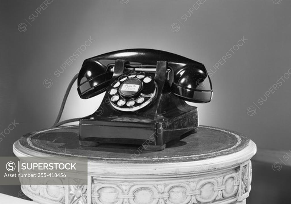 Stock Photo: 255-418456 Old fashioned phone on carved post