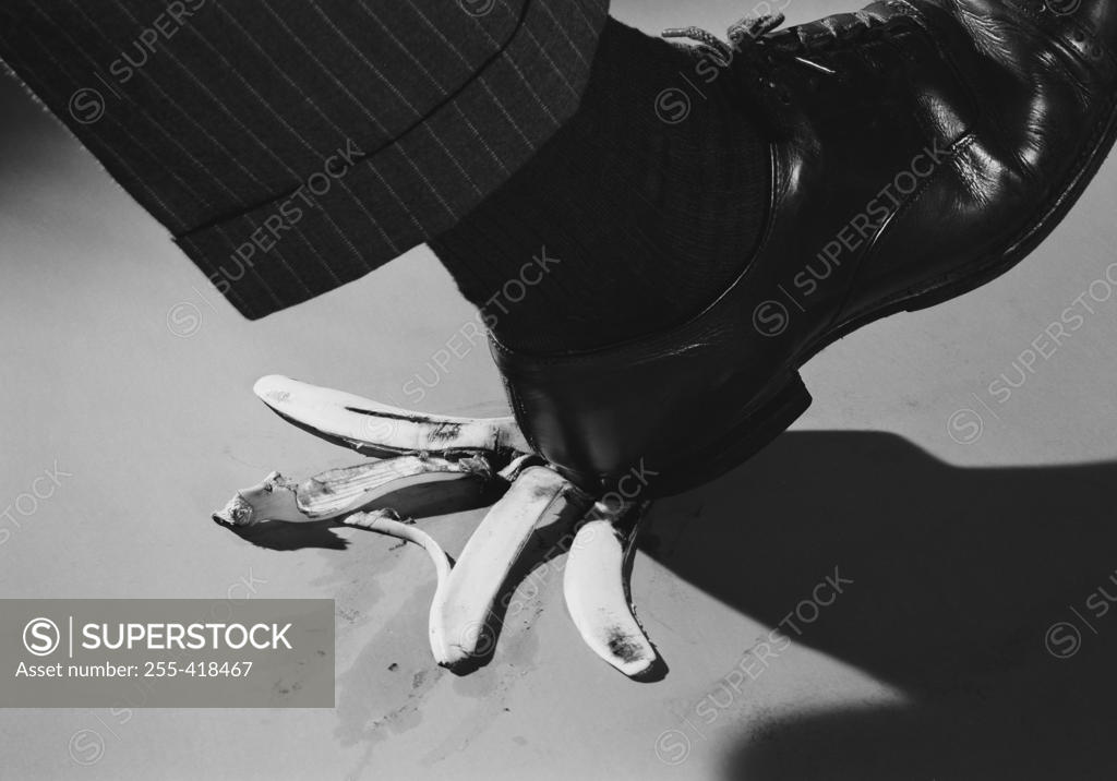 Stock Photo: 255-418467 Foot of man about to step on banana peel