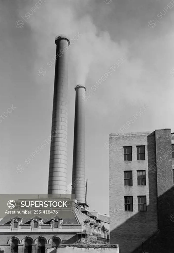 Factory with smoking chimneys, low angle view