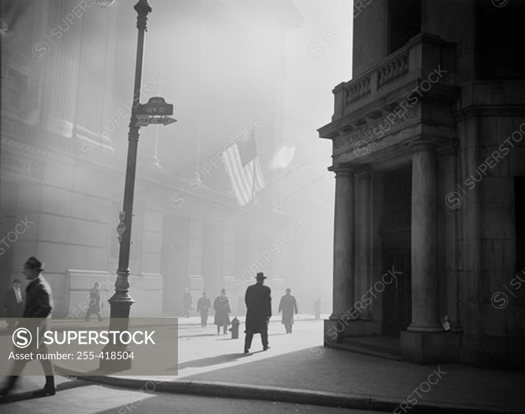 Stock Photo: 255-418504 USA, New York State, New York City, Manhattan, Street with walking people and American flag hanging