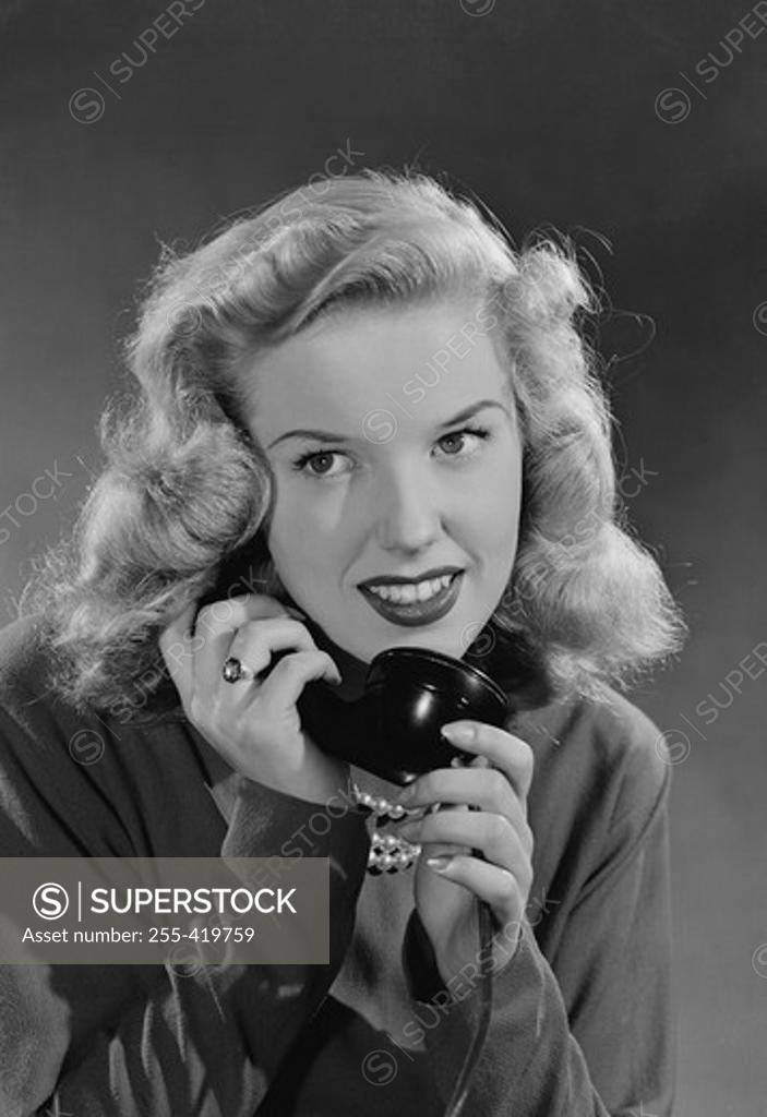 Stock Photo: 255-419759 Portrait of woman talking on phone