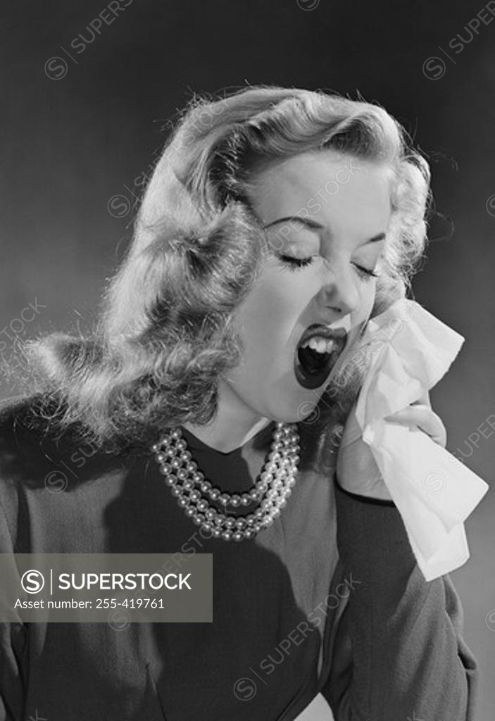 Stock Photo: 255-419761 Portrait of woman sneezing