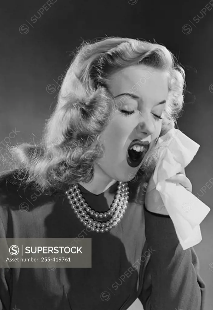 Portrait of woman sneezing