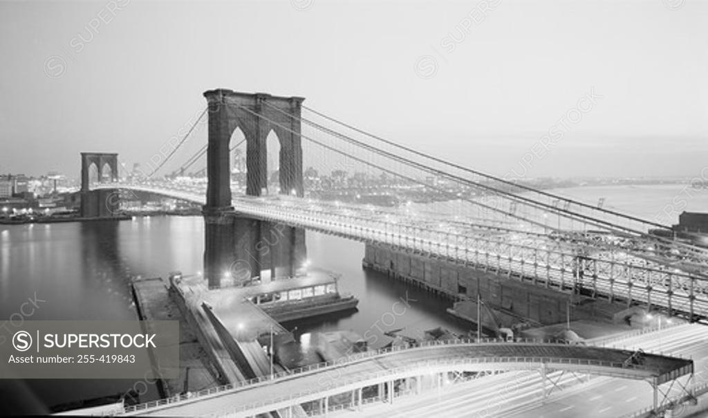 Stock Photo: 255-419843 USA, New York State, New York City, Night view of Brooklyn Bridge with Brooklyn in background from Manhattan side
