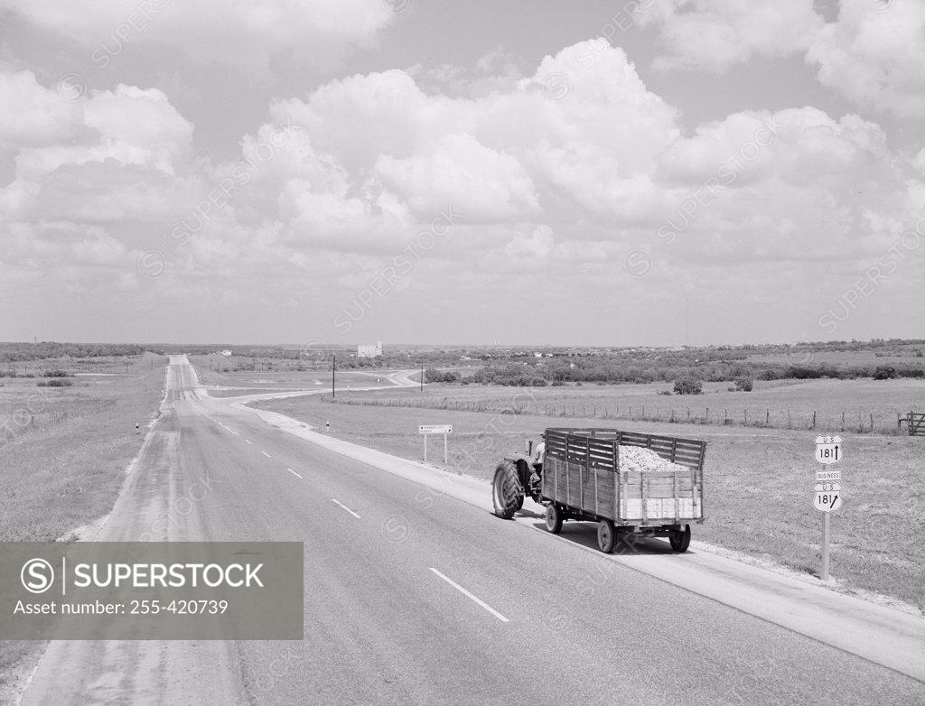 Stock Photo: 255-420739 USA, Texas, Tractor with trailer on country road