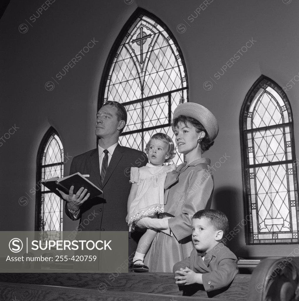 Stock Photo: 255-420759 Family with daughter and son singing in church
