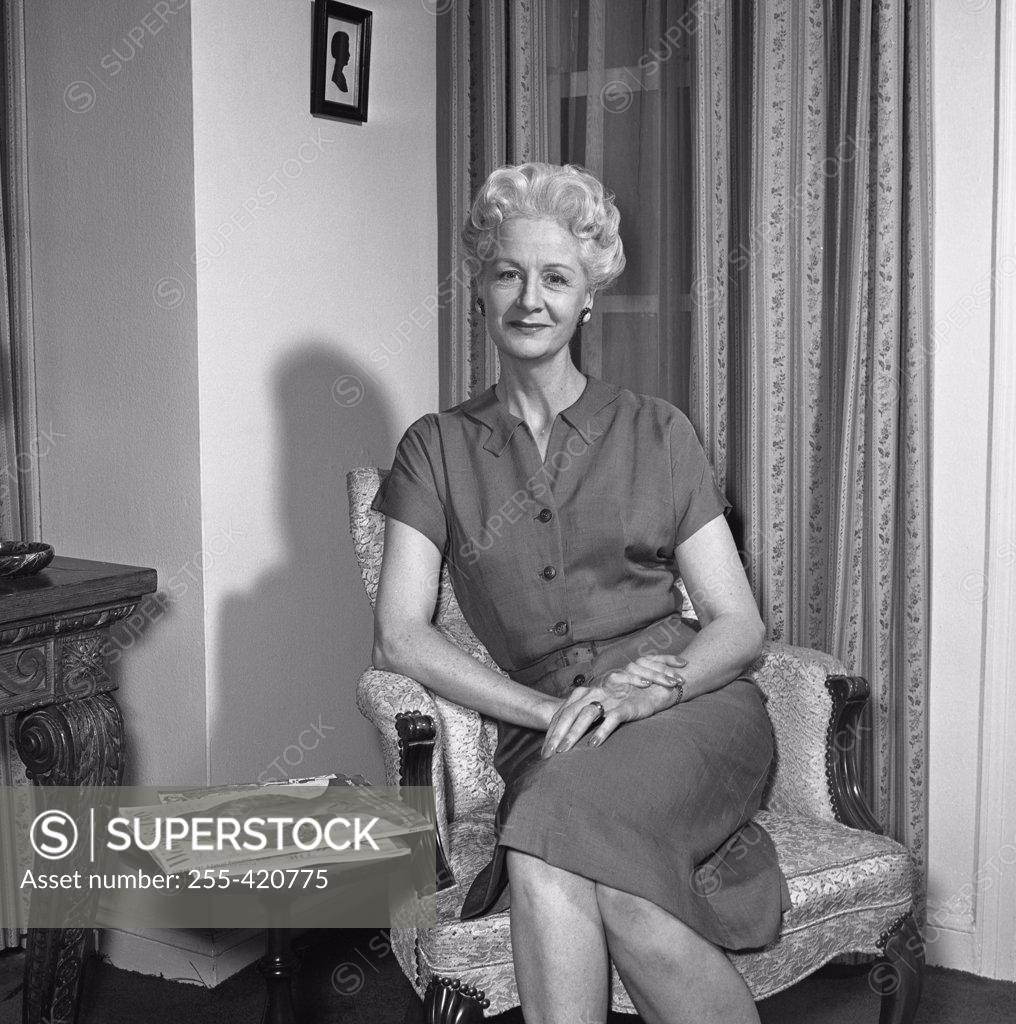 Stock Photo: 255-420775 Portrait of mature woman sitting in armchair