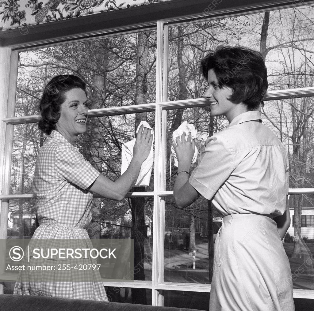 Stock Photo: 255-420797 Mother and adult daughter cleaning window