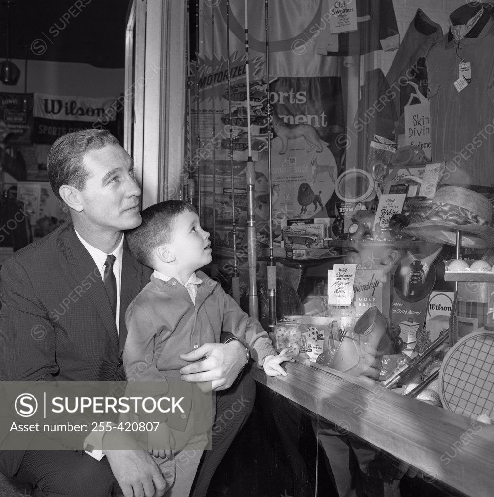 Stock Photo: 255-420807 Father and son watching window display