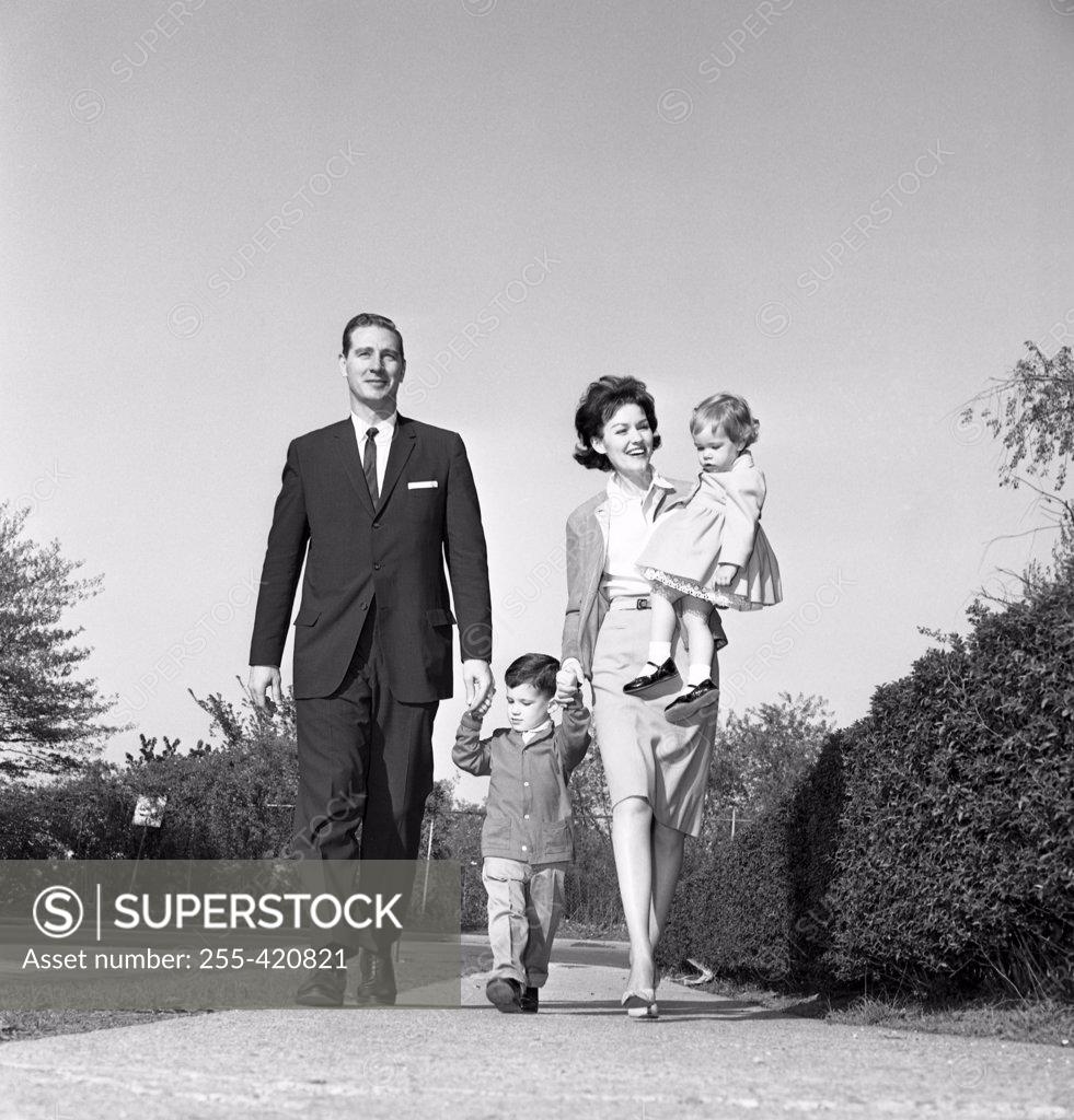 Stock Photo: 255-420821 Family with daughter and son walking in park
