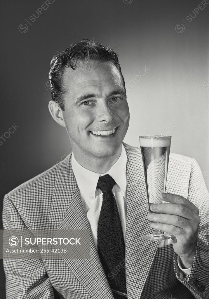 Stock Photo: 255-4213B Portrait of a mid adult man holding a glass of beer