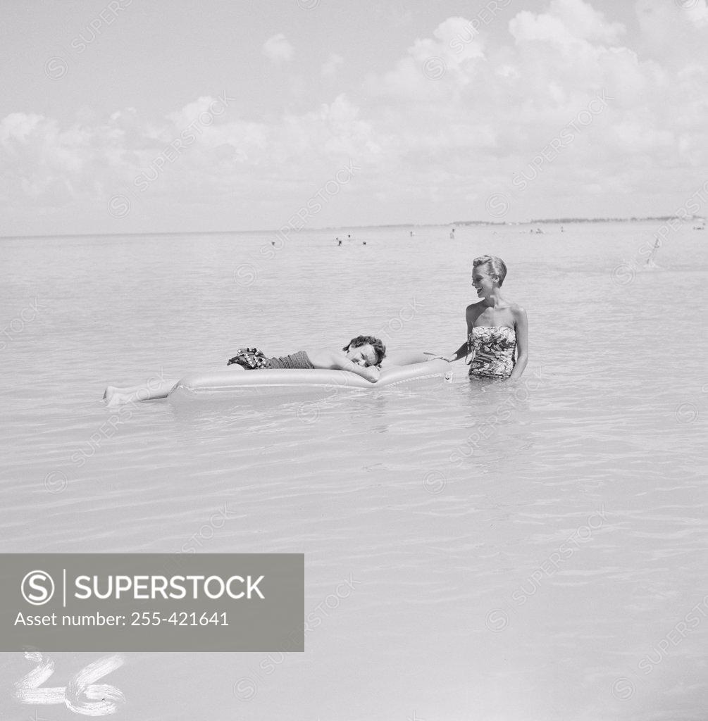 Stock Photo: 255-421641 Young women relaxing in sea