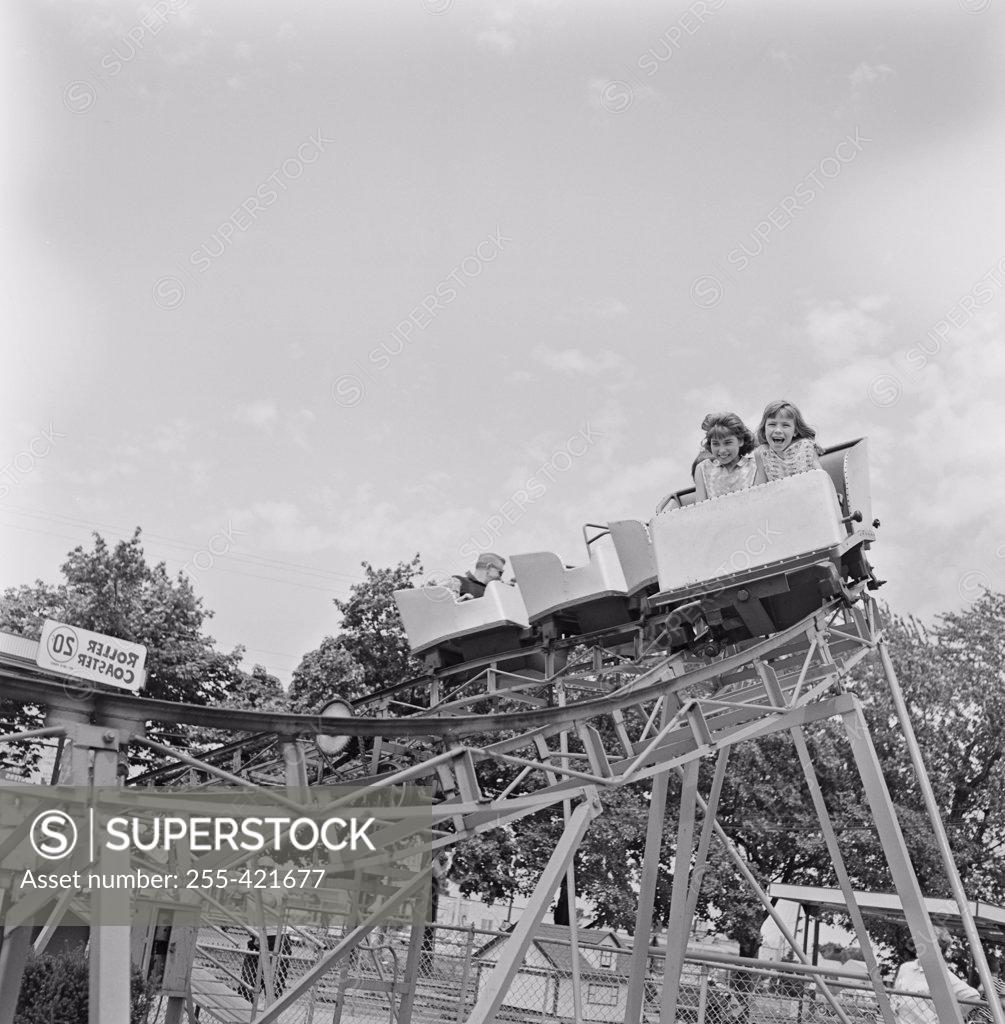 Stock Photo: 255-421677 Girls riding rollercoaster