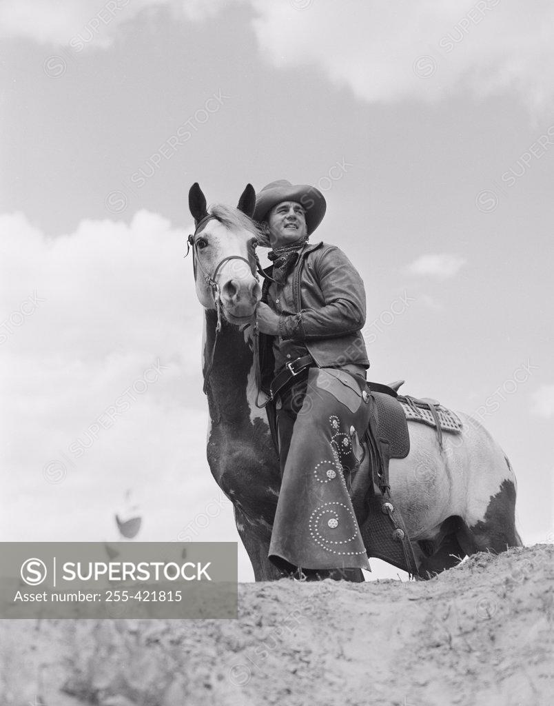 Stock Photo: 255-421815 Cowboy on top of escarpment