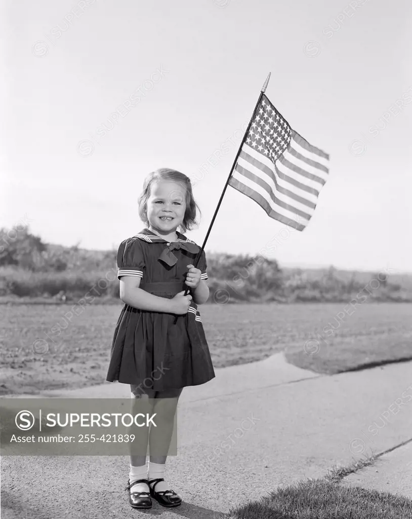 Girl holding US flag