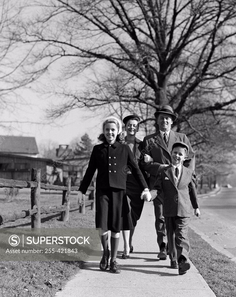Stock Photo: 255-421843 Parents with children on sidewalk