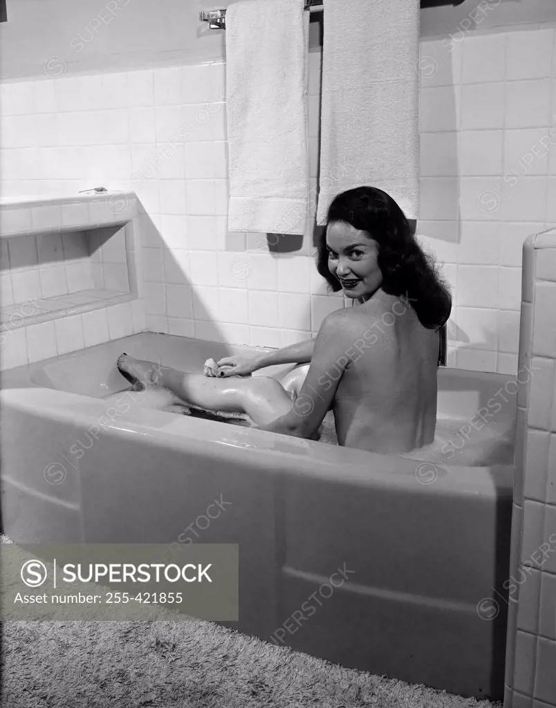 Young woman taking bath