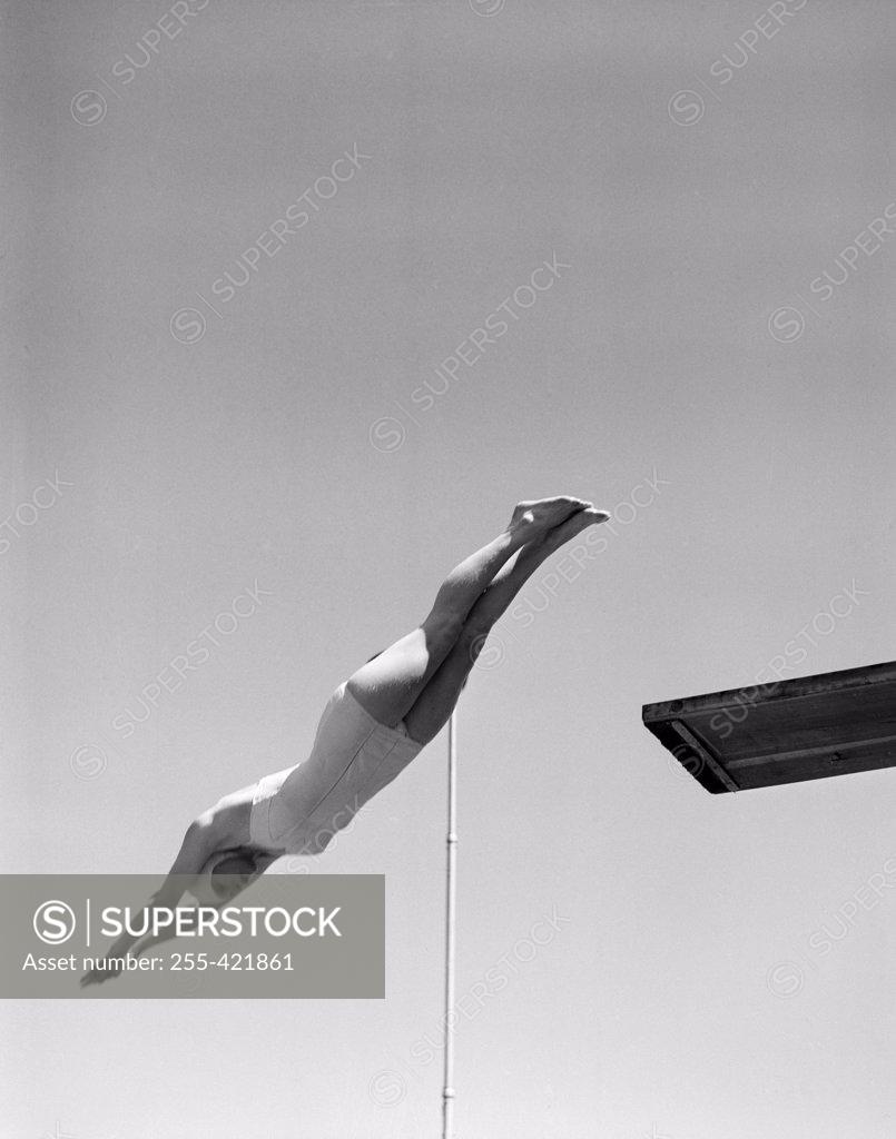 Stock Photo: 255-421861 Swimmer jumping off diving board