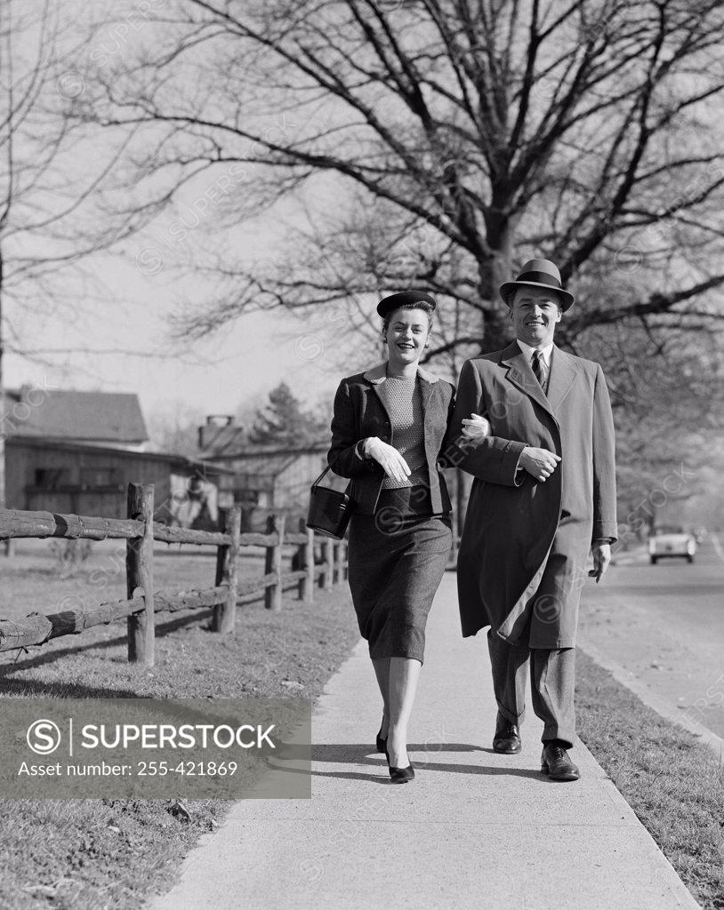 Stock Photo: 255-421869 Mid adult couple walking down street