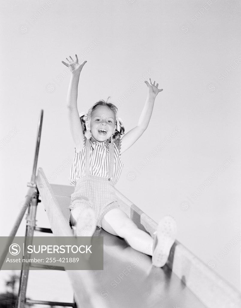 Stock Photo: 255-421889 Low angle view of girl on slide