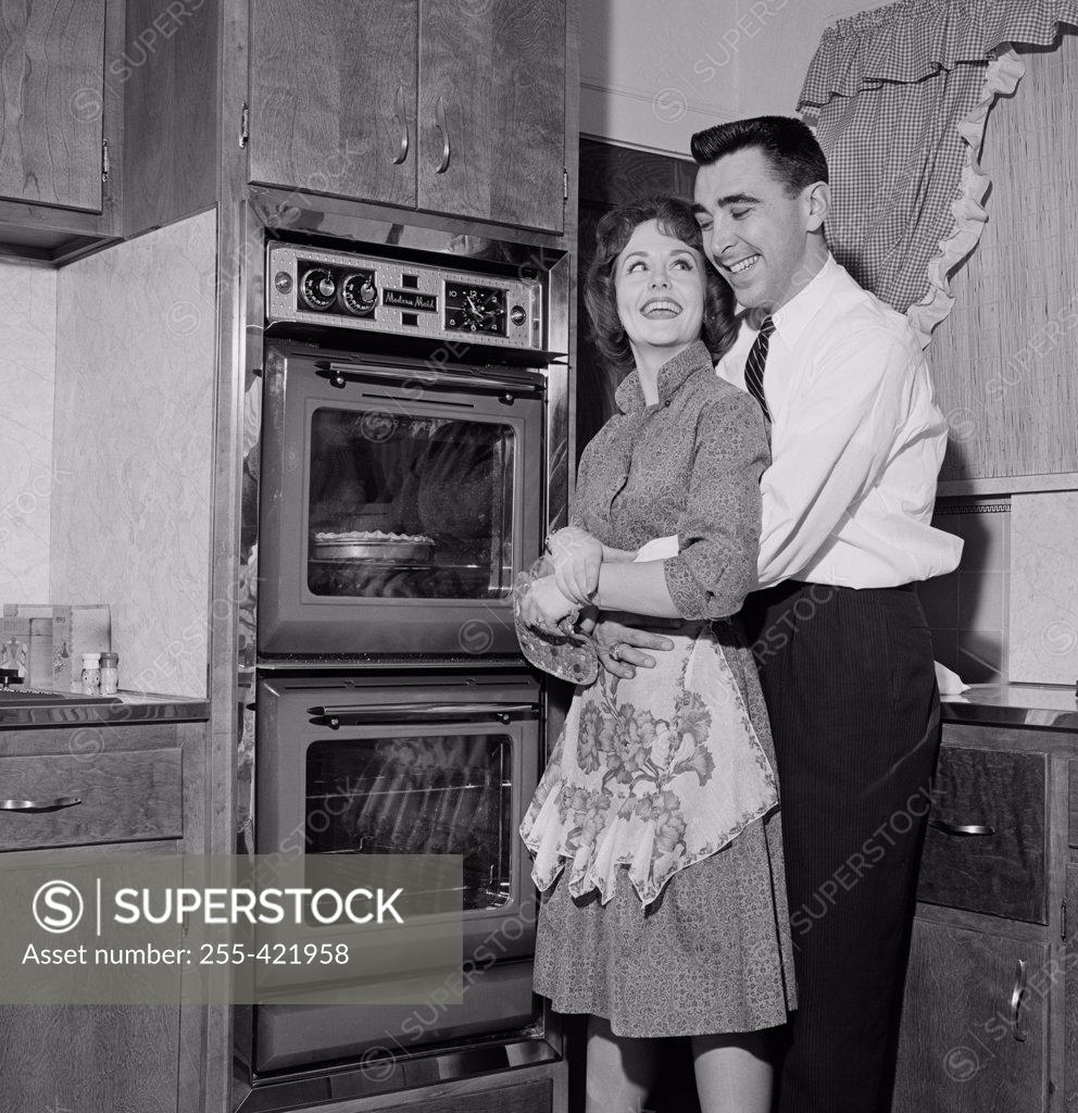 Stock Photo: 255-421958 Happy couple in domestic kitchen