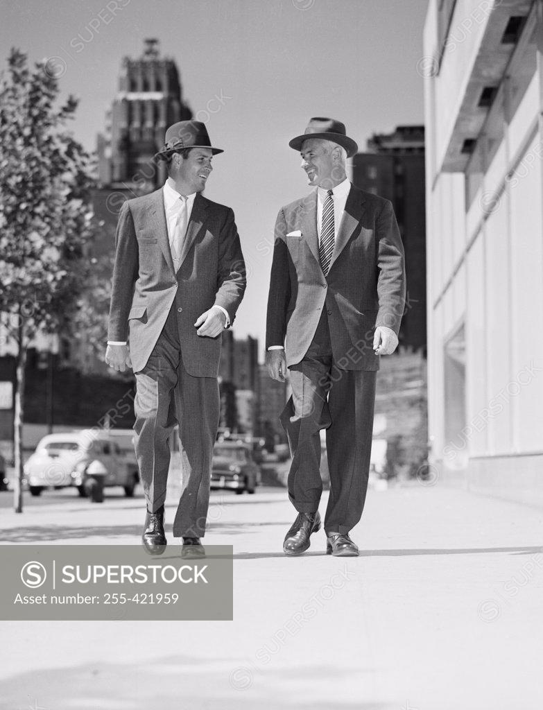 Stock Photo: 255-421959 Pair of businessmen walking in downtown