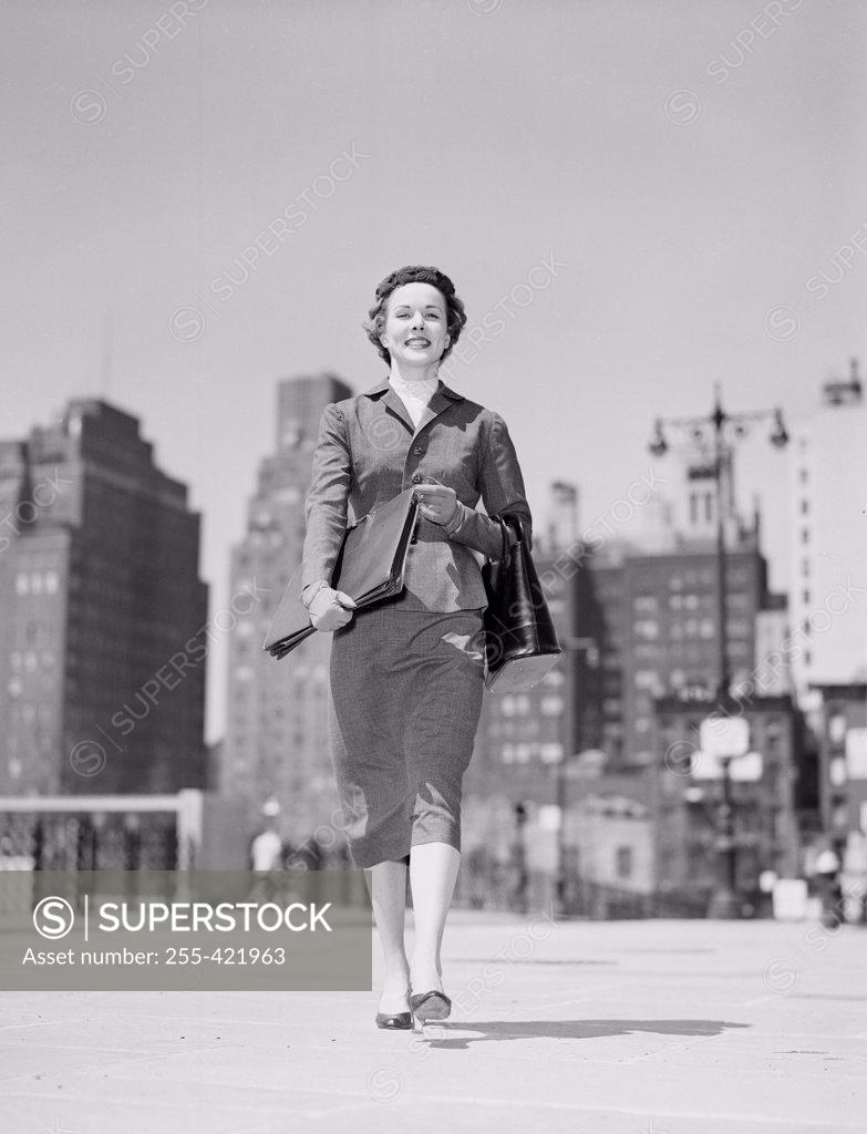 Stock Photo: 255-421963 Cheerful businesswoman walking in downtown