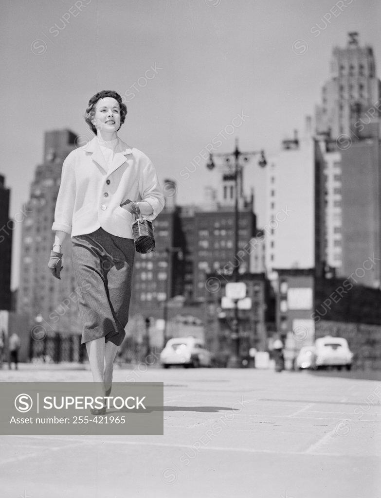 Stock Photo: 255-421965 Cheerful businesswoman walking in downtown
