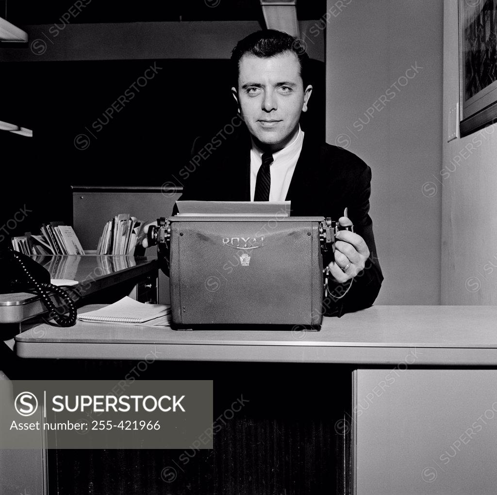 Stock Photo: 255-421966 Portrait of businessman in office environment