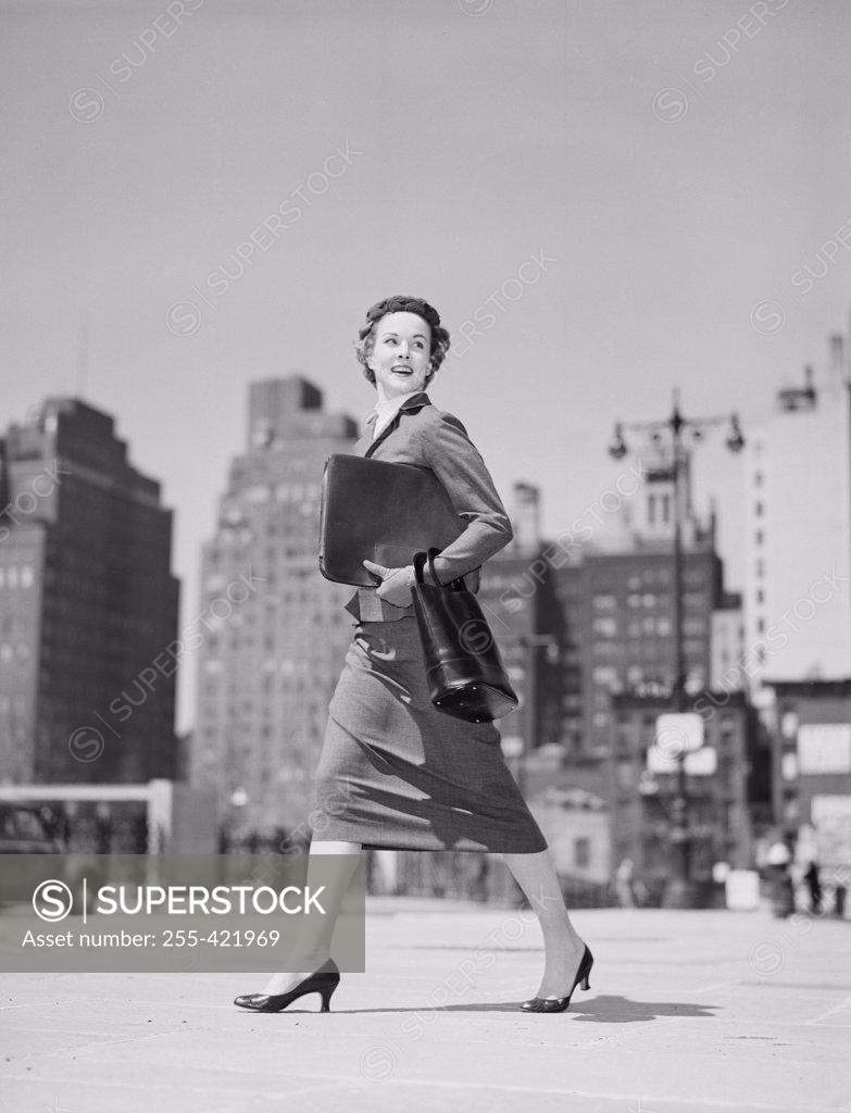 Stock Photo: 255-421969 Cheerful businesswoman walking in downtown
