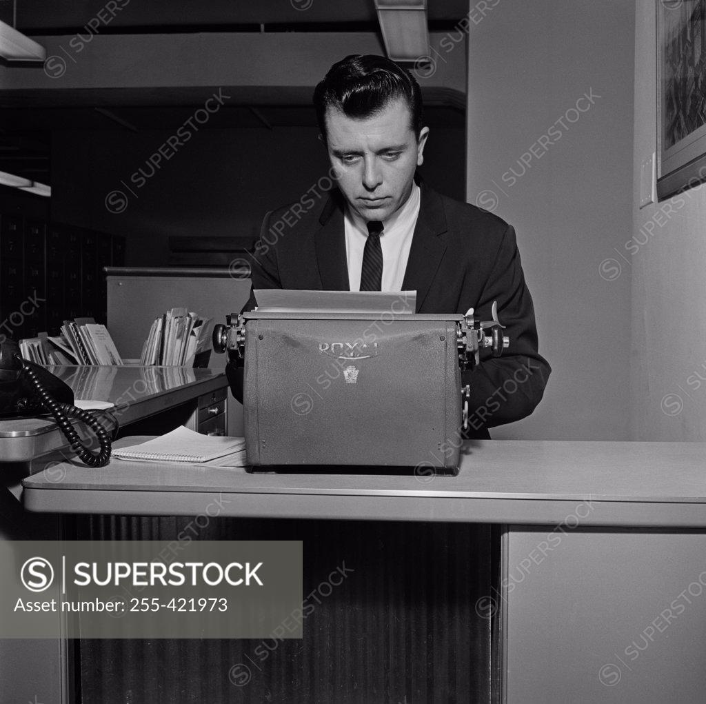 Stock Photo: 255-421973 Businessman typing in office environment