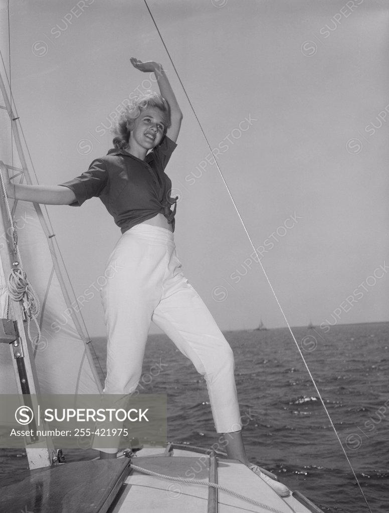 Stock Photo: 255-421975 Young attractive woman weaving from yacht deck
