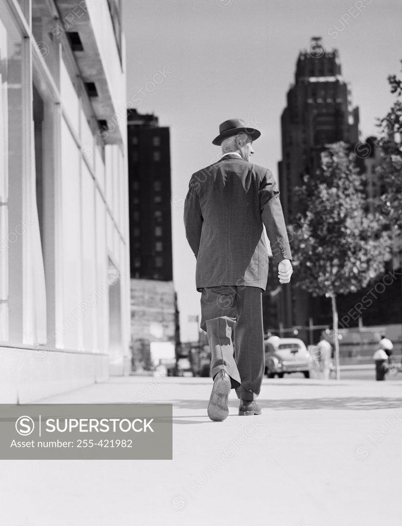 Stock Photo: 255-421982 Rear view of businessman walking in downtown