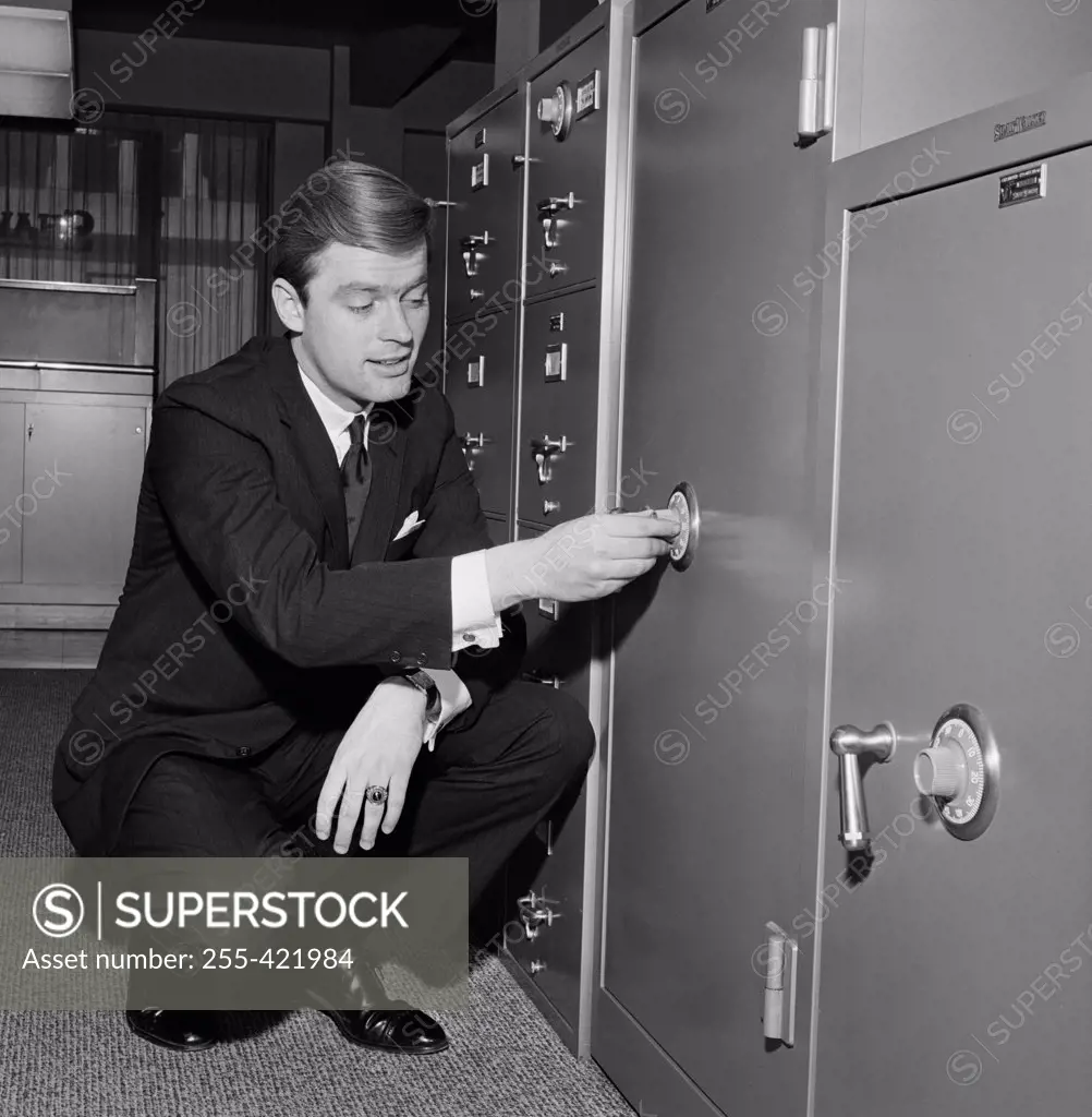Businessman opening safe