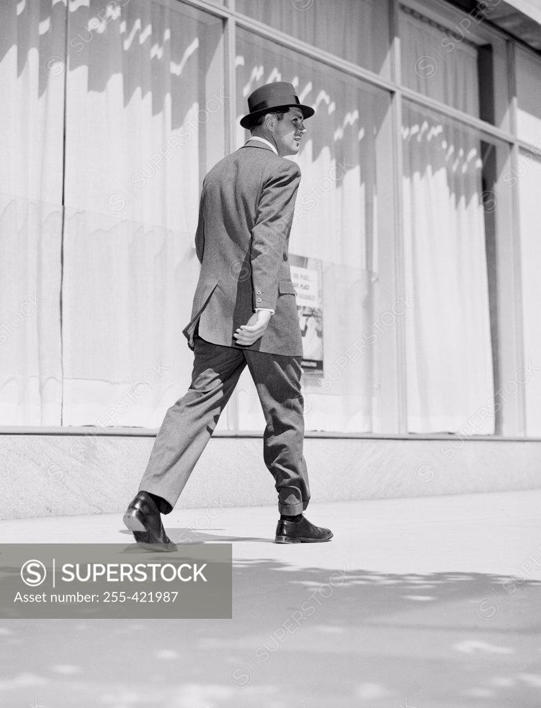 Stock Photo: 255-421987 Rear view of businessman walking in downtown