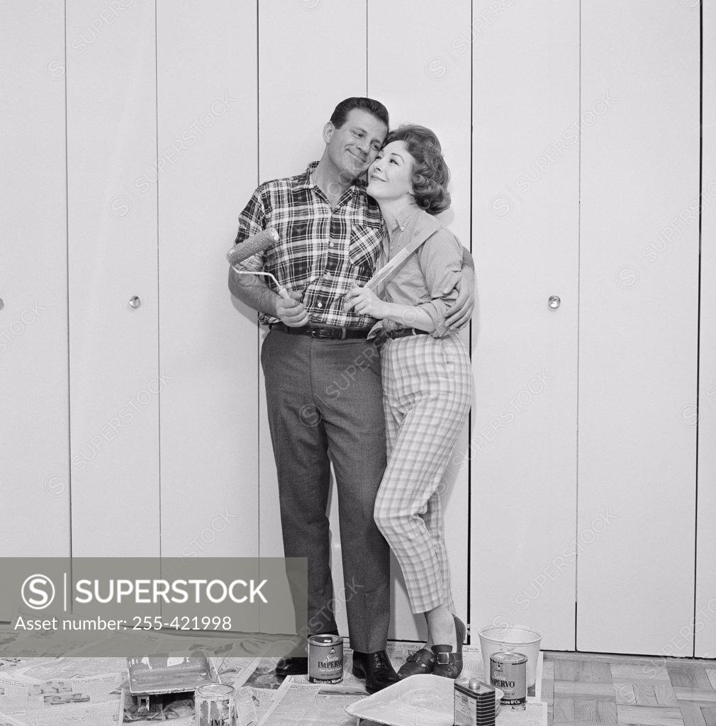 Stock Photo: 255-421998 Couple in front of freshly painted garage door