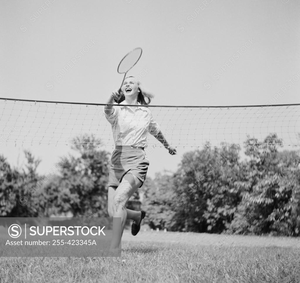 Stock Photo: 255-423345A Young woman playing badminton