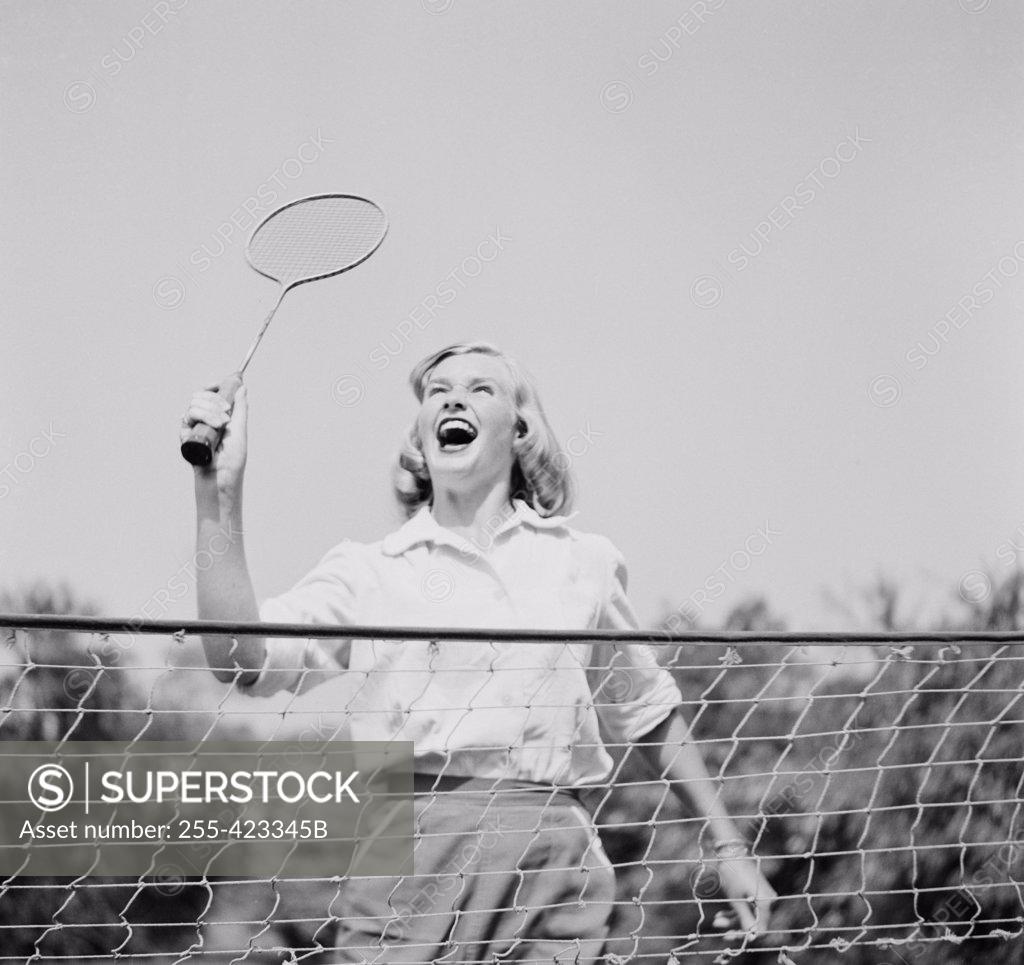 Stock Photo: 255-423345B Close-up view of young woman playing badminton